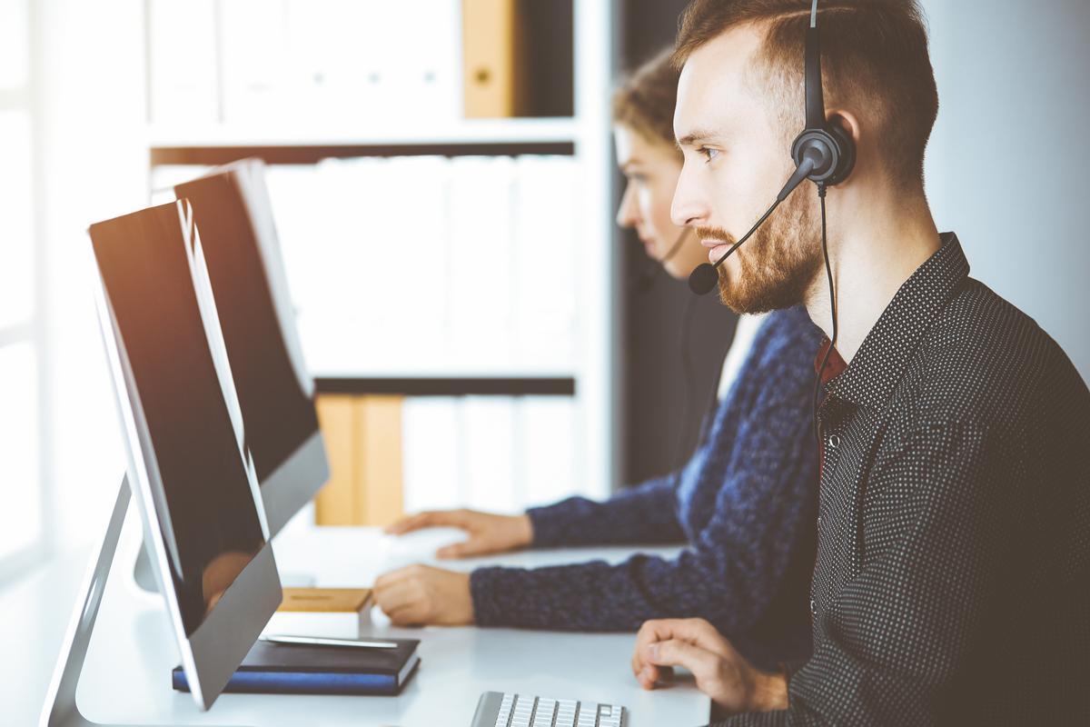 Man with headphones working in Contact Center
